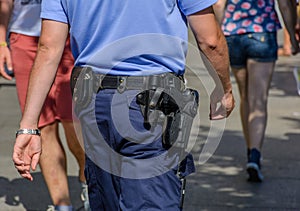 German police officer observing people.