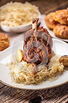 German pork knuckle with sauerkraut and baked potatoes