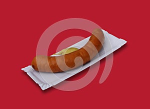 A German pork sausage served with mustard.