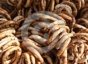 German pretzels stack one over each other, group of thin dry pretzels on rope