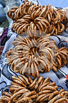 German pretzels stack one over each other, group of thin dry pretzels on rope