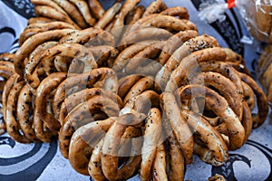 German pretzels stack one over each other, group of thin dry pretzels on rope