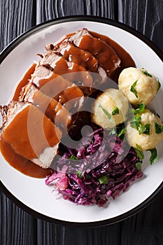 German roast pot Sauerbraten served with potato dumplings and re photo