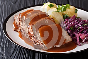 German Sauerbraten is a beef stew with a spicy sauce served with photo