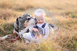 German Shepherd Miz Breed Dog Kissing Baby Girl on Cheek photo