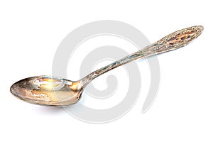 German silver or cupronickel spoon with visible oxidation layer isolated on white baclground