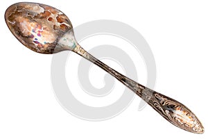 German silver or cupronickel spoon with visible oxidation layer isolated on white baclground