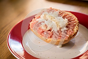 German snack buns with raw minced pork meat, pepper and onions  on bread bun roll