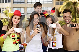 German soccer fans holding smartphones