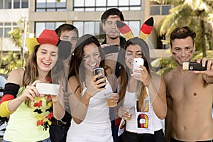 German soccer fans holding smartphones