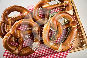 German soft Brezel pretzel with salt, chives and butter in bread basket