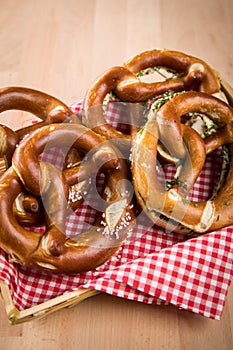 German soft Brezel pretzel with salt, chives and butter in bread basket