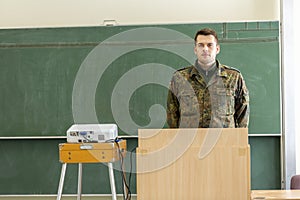 German soldier stands in a classroom
