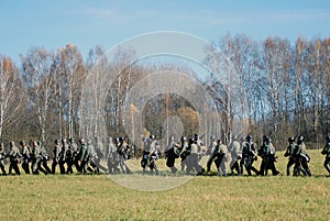 German soldiers-reenactors walk with guns