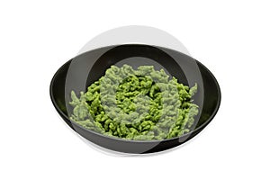 German Spaetzle made with Allium Ursinum or wild garlic in a bowl isolated on white