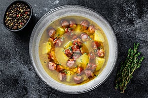 German Split pea soup with smoked sausages and meat. Black background. Top view. Copy space