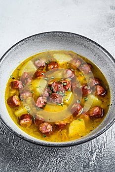 German Split pea soup with smoked sausages. White background. Top view