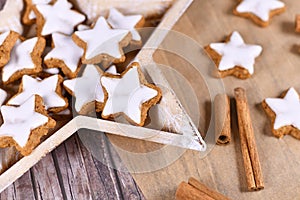German star shaped glazed Christmas cinnamon cookies called `Zimtsterne` made with amonds, egg white, sugar, cinnamon and flour