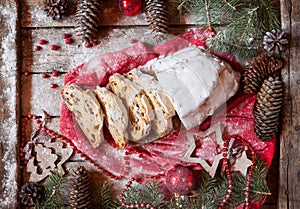 German Stollen Christmas Cake and Celebration Decorations. Traditional baking with Berries, Nuts, Marzipan.