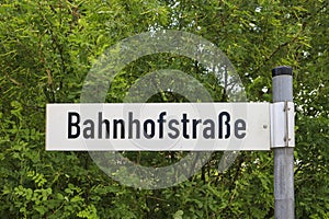 German street sign translates into railroad station street in English