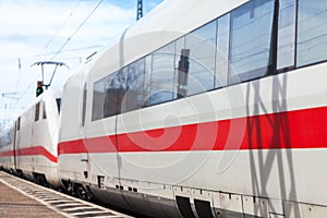 German train passes a train station