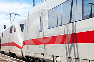 German train passes a train station