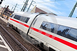 German train passes a train station