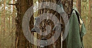 German Wehrmacht Infantry Soldier's Military Equipment Of World War II. Lanterns, binoculars, coat Hanging In Tree