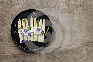 German White Asparagus with sauce, wild garlic, and edible flowers.