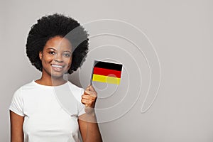German woman holding flag of Germany Education, business, citizenship and patriotism concept