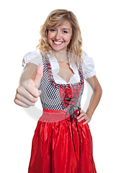 German woman in a traditional bavarian dirndl showing thumb up