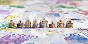German word Finanzen on coin stacks, cash background