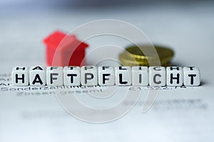 German Word LIABILITY formed by alphabet blocks: HAFTPFLICHT