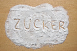 German word Zucker written in sugar photo