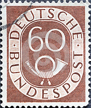 GERMANY - CIRCA 1951: a postage stamp from Germany, showing a sign Deutsche Bundespost with post horn  brown
