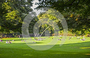 Germany, Cologne. Stay on the grass. People relax on the grass in the Park. Sunny day