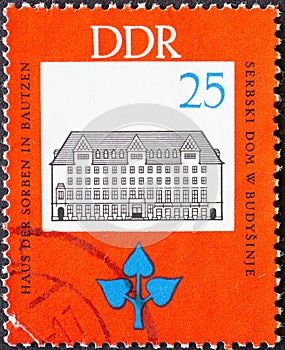 GERMANY, DDR - CIRCA 1966  : a postage stamp from Germany, GDR showing the house of the Sorbs in Bautzen. 150th birthday of Jan Ar
