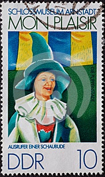 GERMANY, DDR - CIRCA 1974 : a postage stamp from Germany, GDR showing a crier of a show booth. Arnstadt Castle Museum, Puppenstadt