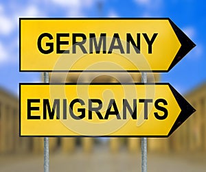 Germany and Emigrants traffic sign with blurred Berlin background photo