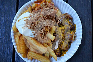 Germany traditional streetfood, portrait of currywurst & pommes photo