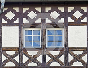 Germany, two windows of traditional decorated half-timbered house building