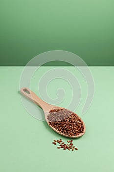 Germinated brown rice. GABA rice in wooden spoon on green background. Selective focus, copy space