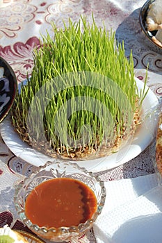 germinated wheat, a symbol of Navruz holiday, and samanu sumalak on the table