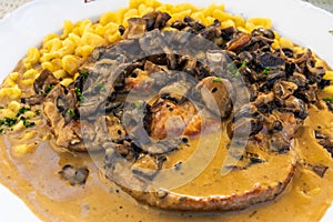 Geschnetzeltes farmer style dish of chopped pork, cooked in sauce, with mushrooms and spatzle