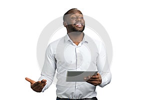 Gesticulating businessman with digital tablet. photo