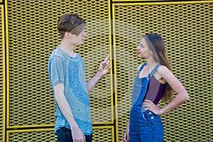 Gesticulating couple of teenagers in argument photo