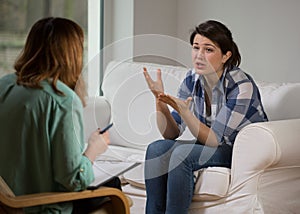 Gesticulating girl talking with psychologist