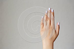 Gesture and sign, hand showing stop on a light background