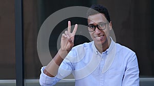 Gesture of Success, Victory Sign by Young Black Handsome Man