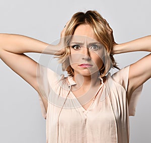 Gesture woman covering her ears with his hands. isolated on gray background